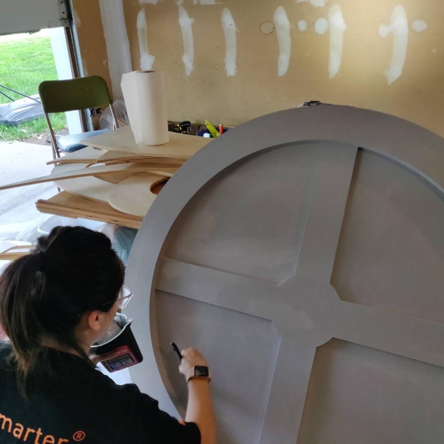 Portfolio | Sarah Myose — Art & Marketing Work Priming wood pieces for the Old Mill logo panel